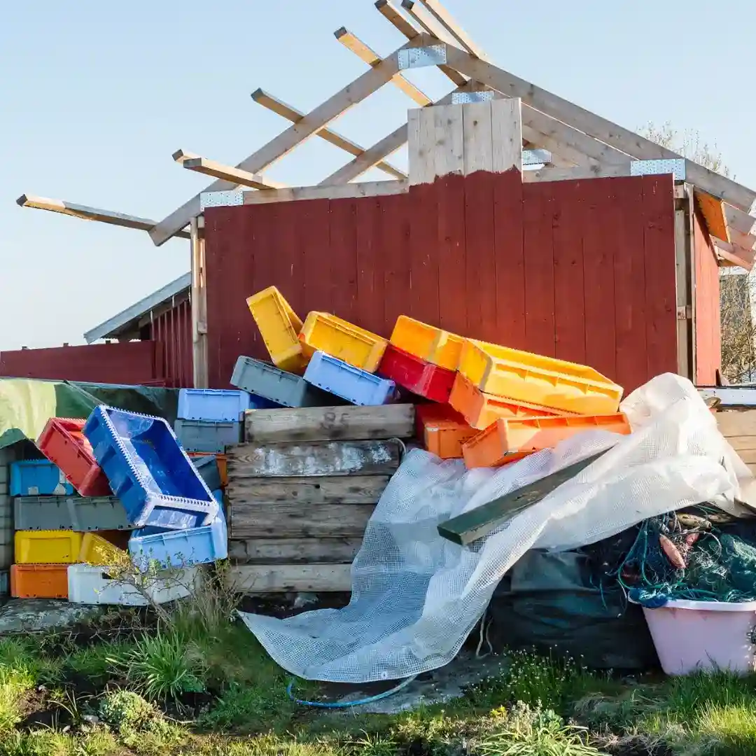 Before shed cleanout - cluttered shed with junk crates 
and debris near Goodlettsville Community Park TN